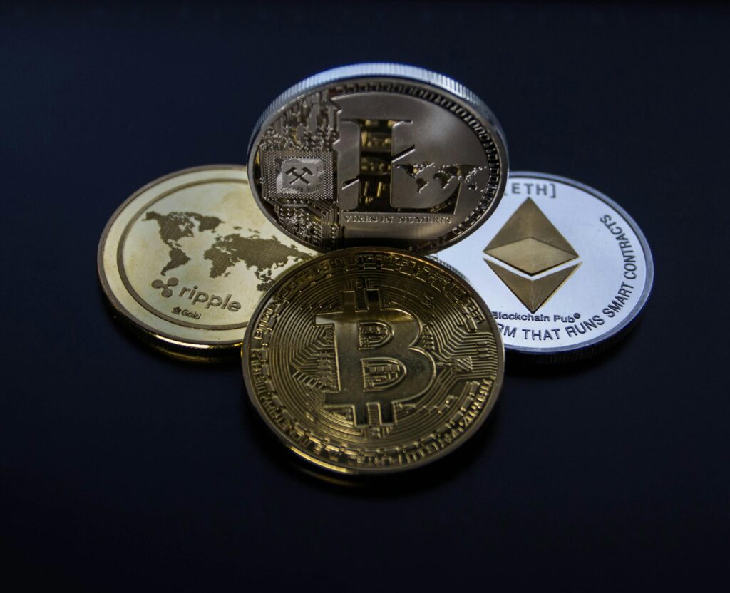 pexels photo 843700 843700 Detailed photo showcasing bitcoin, ethereum, litecoin, and ripple coins representing digital currency.