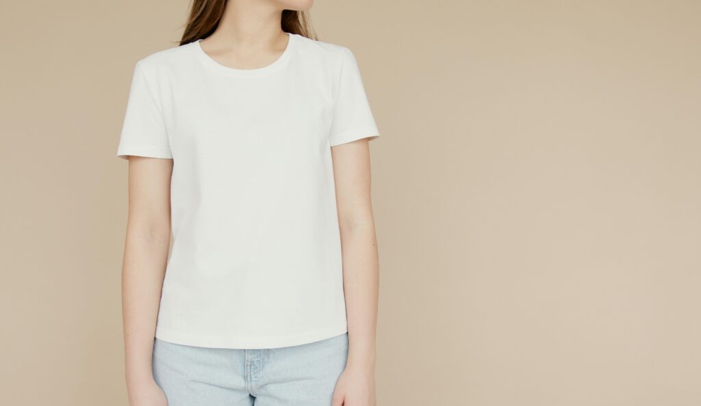 pexels photo 6786614 6786614 Mockup of a woman in a white t-shirt and jeans on a beige background, ideal for fashion branding.