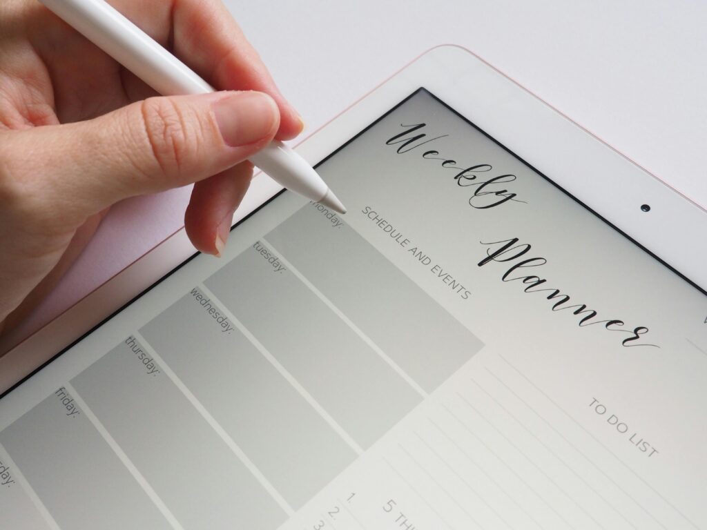 pexels photo 768472 768472 A stylus writing in a digital weekly planner on a tablet screen, ideal for organization.